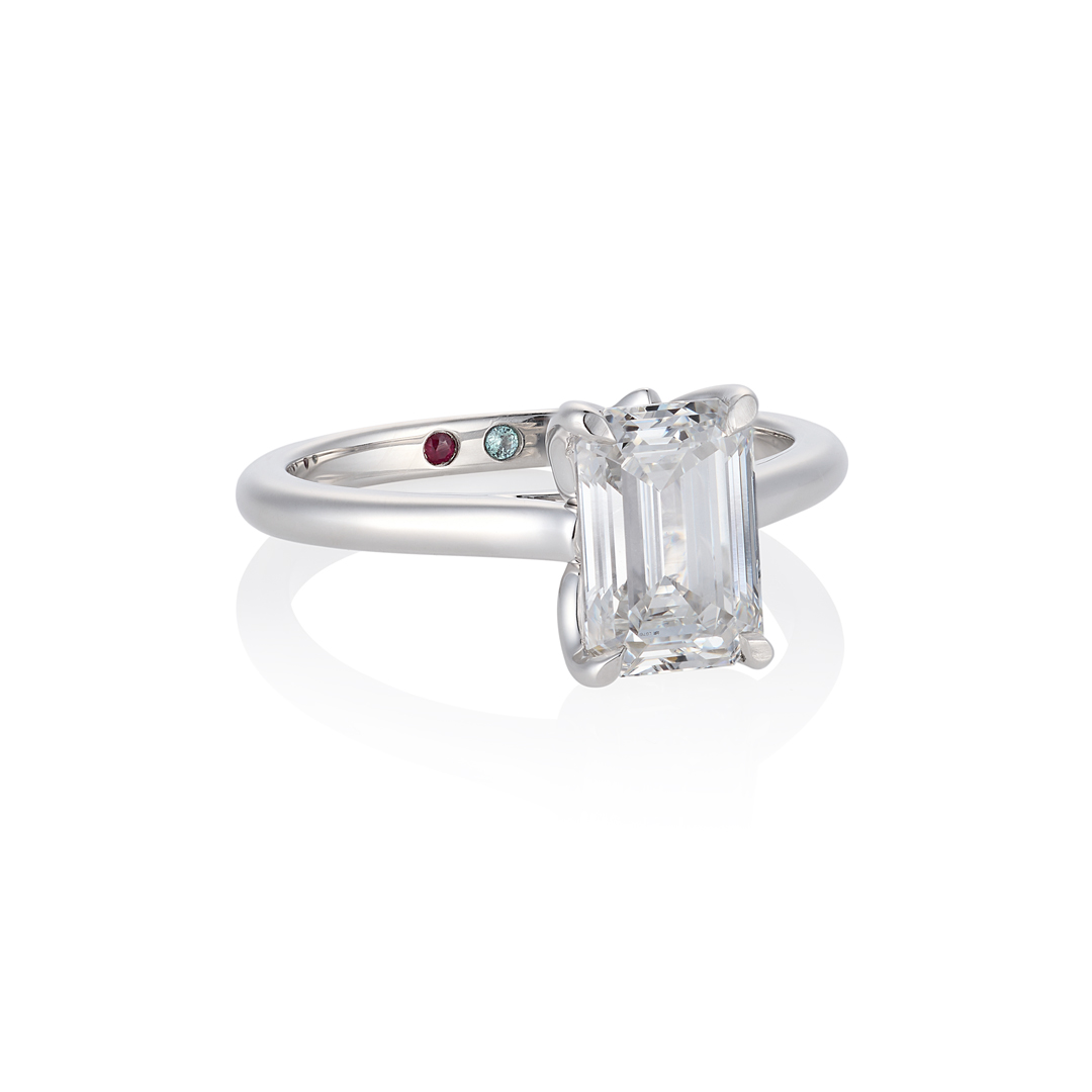 Emerald-cut solitaire with hidden birthstones on the band